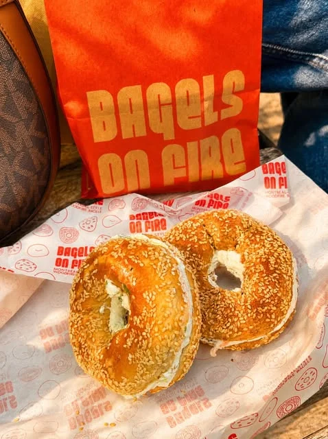 Sesame bagels spread with cream cheese