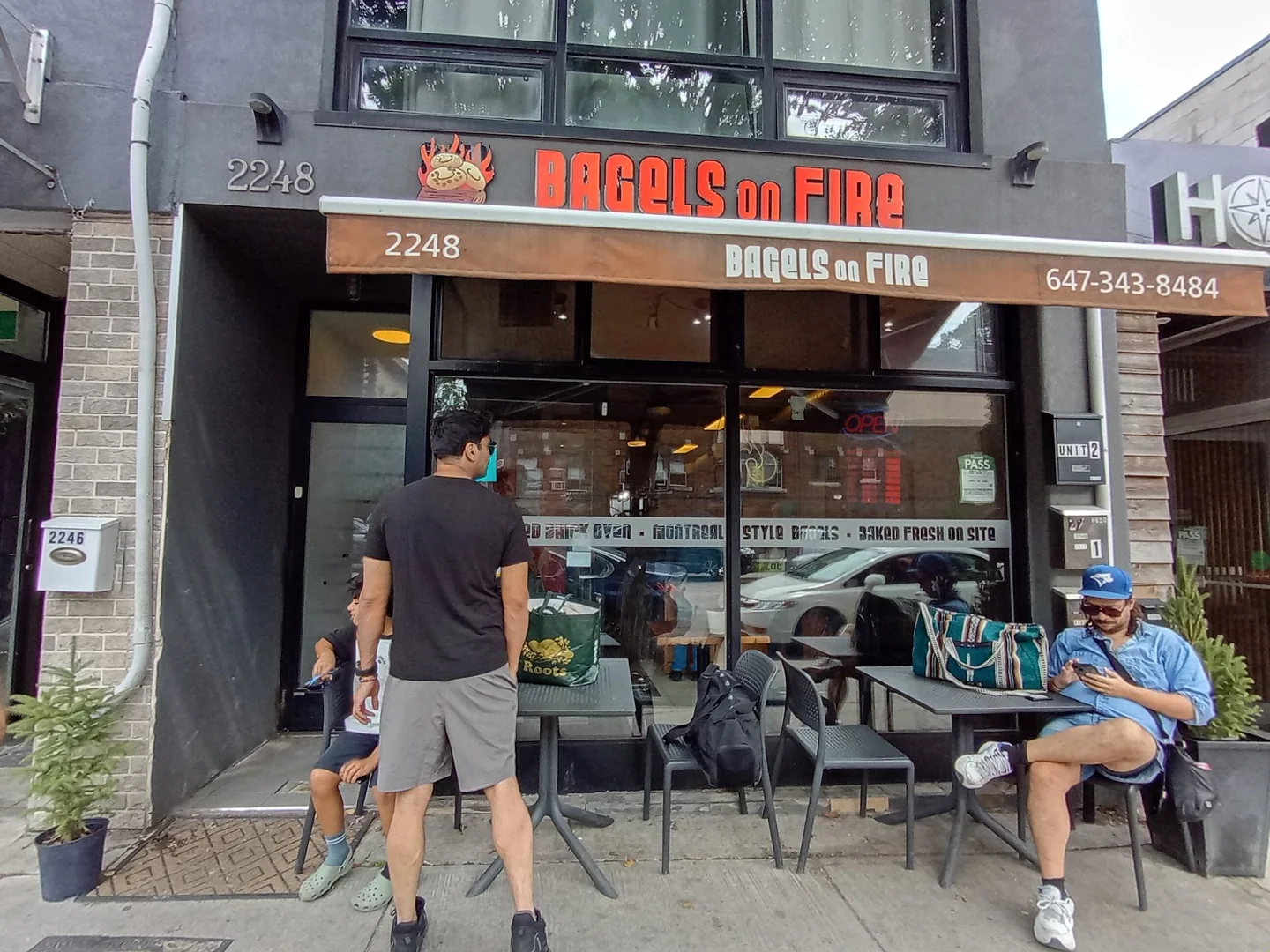 Customers outside Bagels on Fire at 2248 Queen Street East
