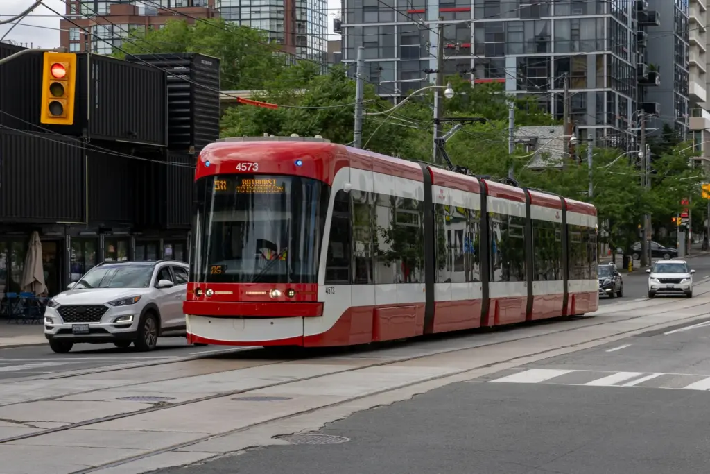 Modern 511 TTC streetcar sharing Bathurst Street with cars