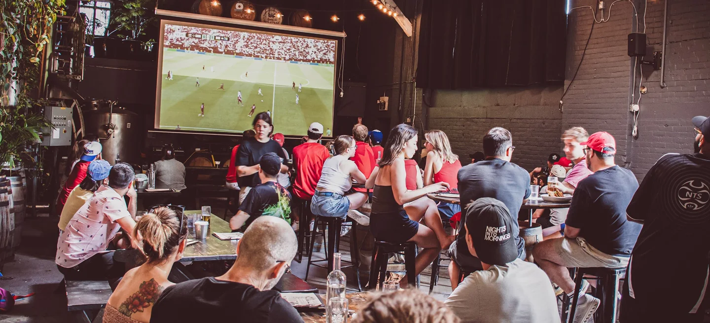 Friends gathered around tables in the Blood Brothers taproom