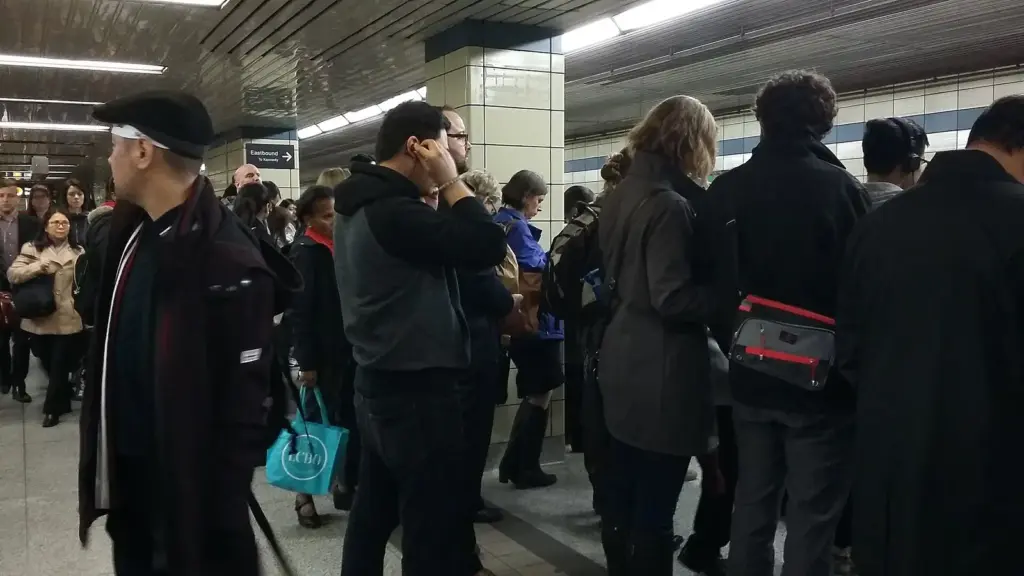 Crowded platform and transfer signs at Bloor-Yonge Station