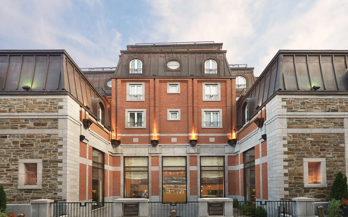 Brick and stone buildings around the entrance courtyard at Auberge Saint-Antoine