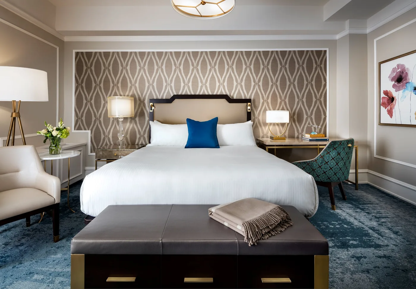 A guest room at the Empress with blue cushions and patterned curtains