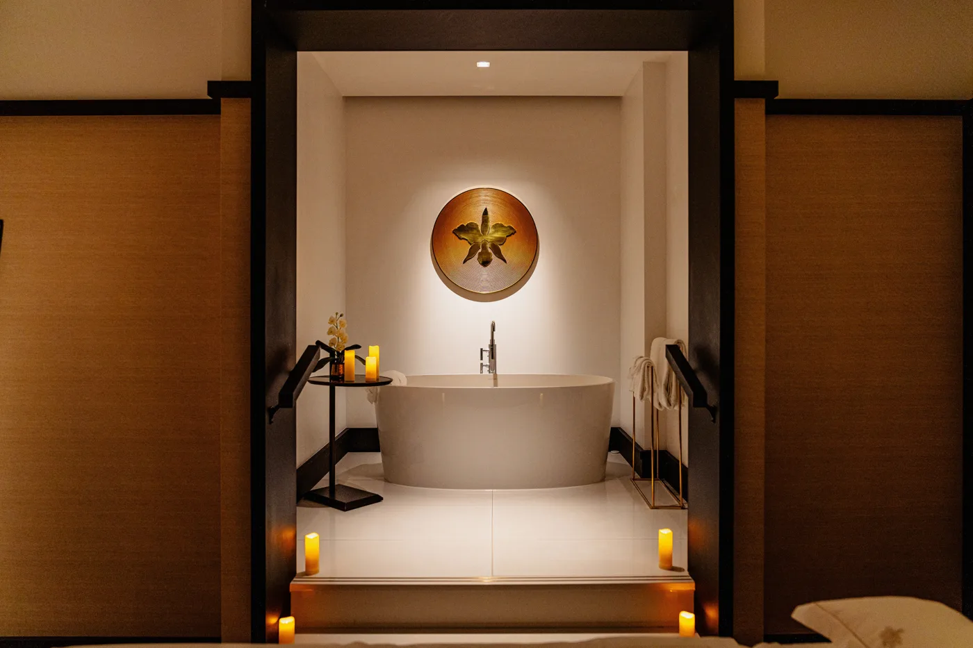 A treatment table in a warmly lit room at Four Seasons Montreal's Guerlain Spa