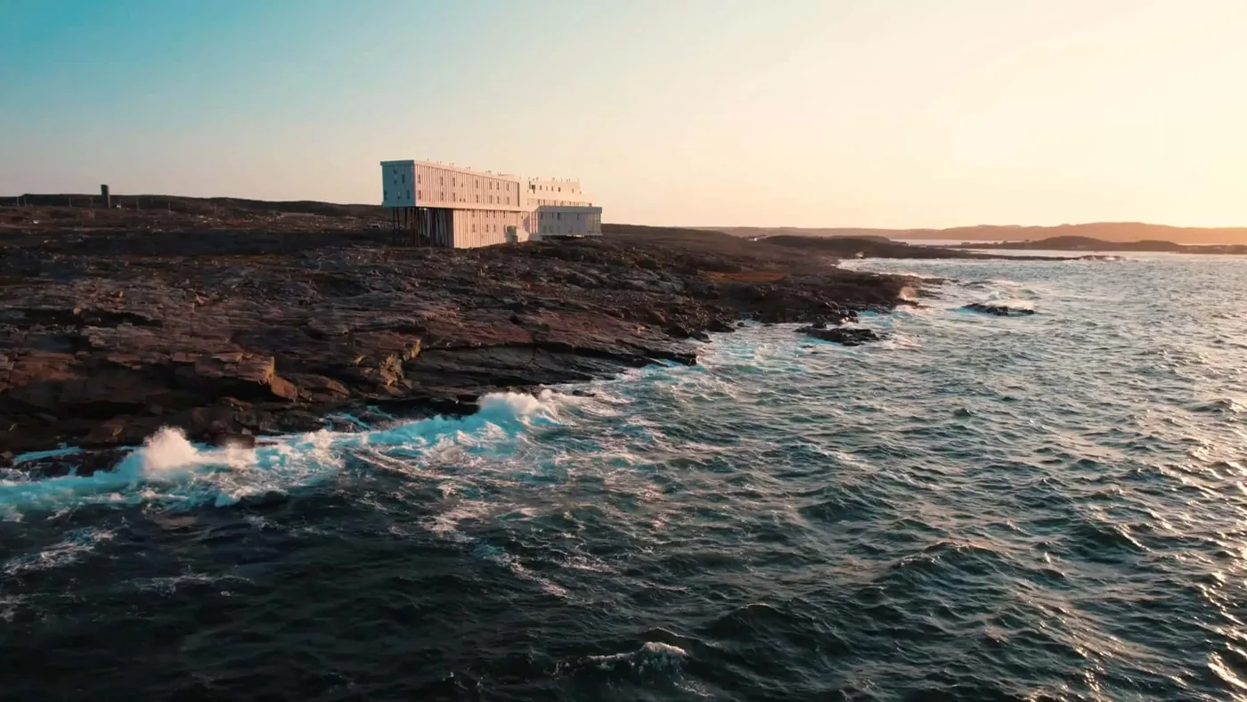 Fogo Island Inn on the rocky Atlantic shoreline in warm evening light