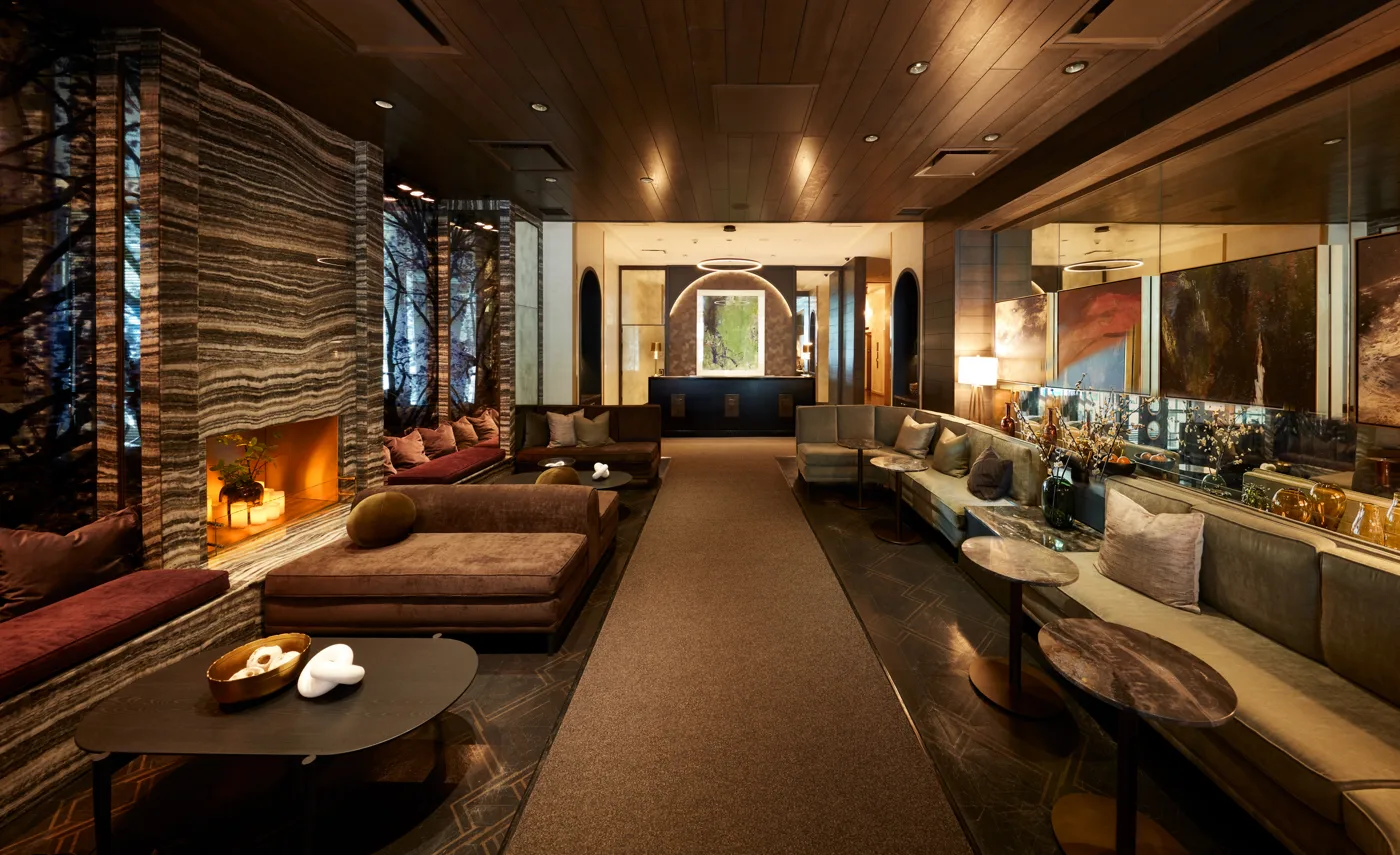Leather seats and a fireplace in the Loden Hotel's warmly lit lounge