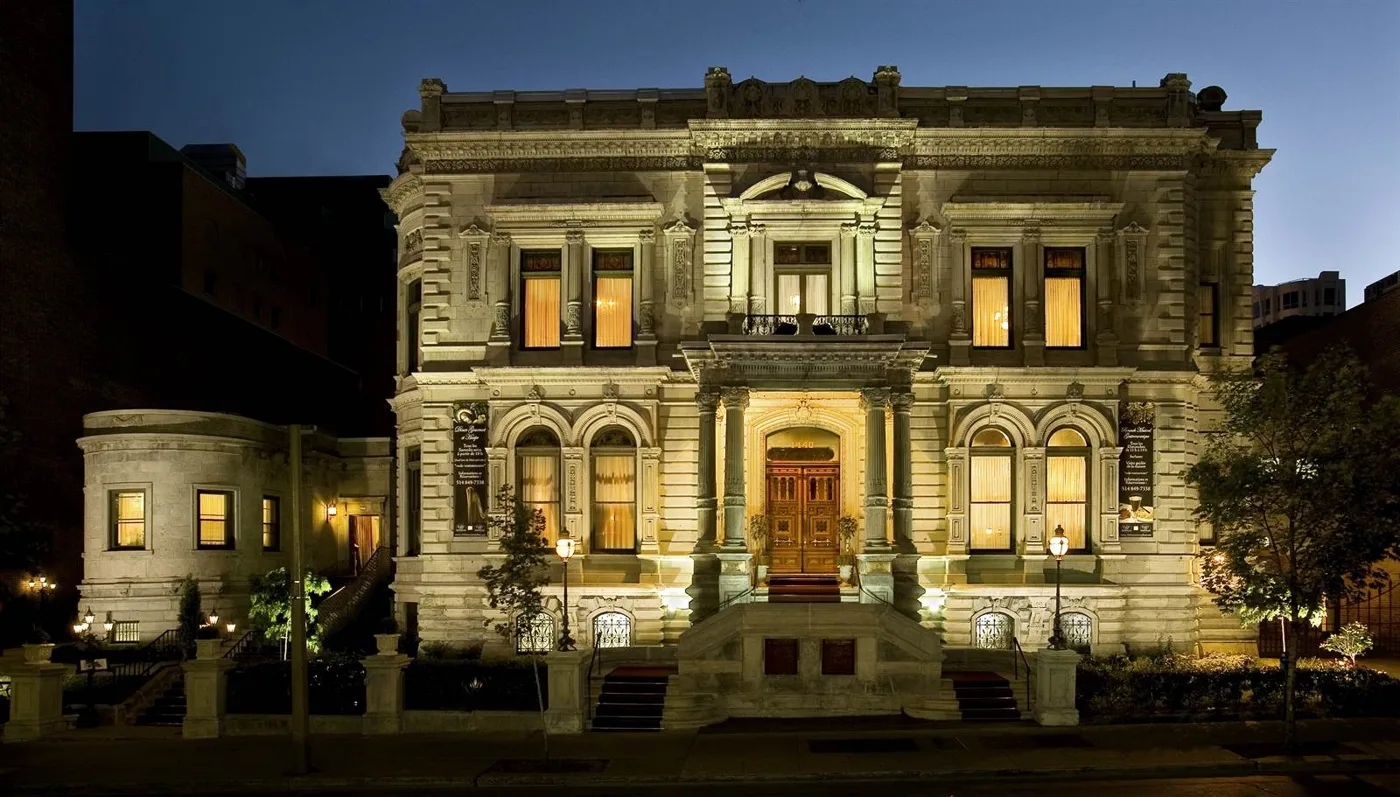 The ornate stone mansion at Le Mount Stephen illuminated at night