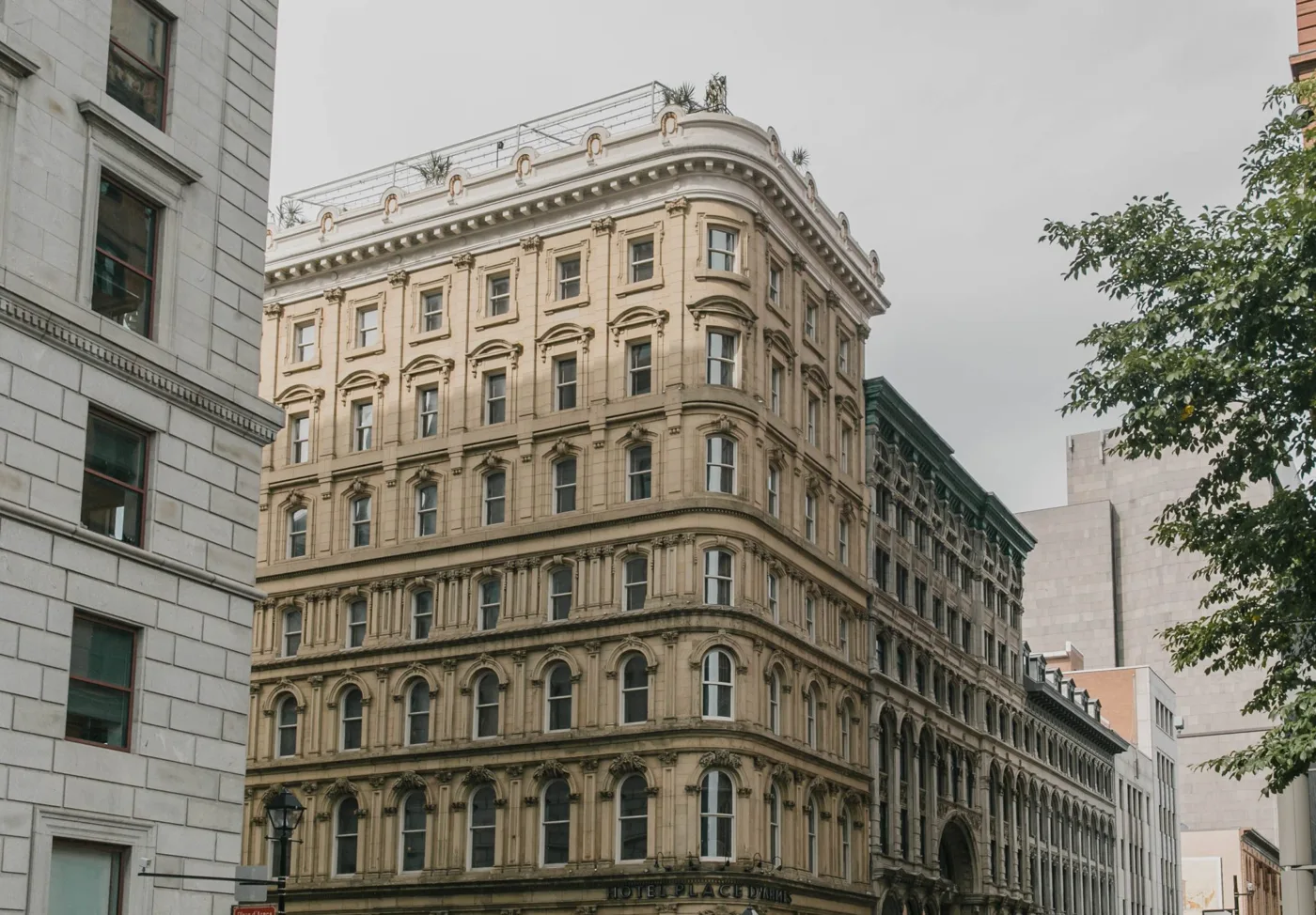 The ornate corner facade of Hotel Place d'Armes in Old Montreal