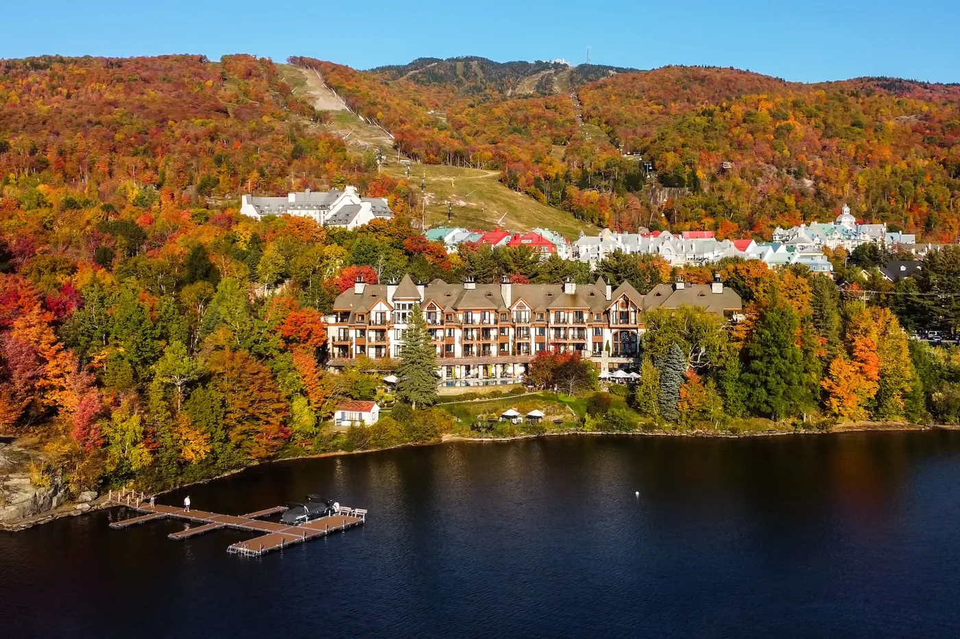 Hotel Quintessence beside Lake Tremblant surrounded by autumn foliage