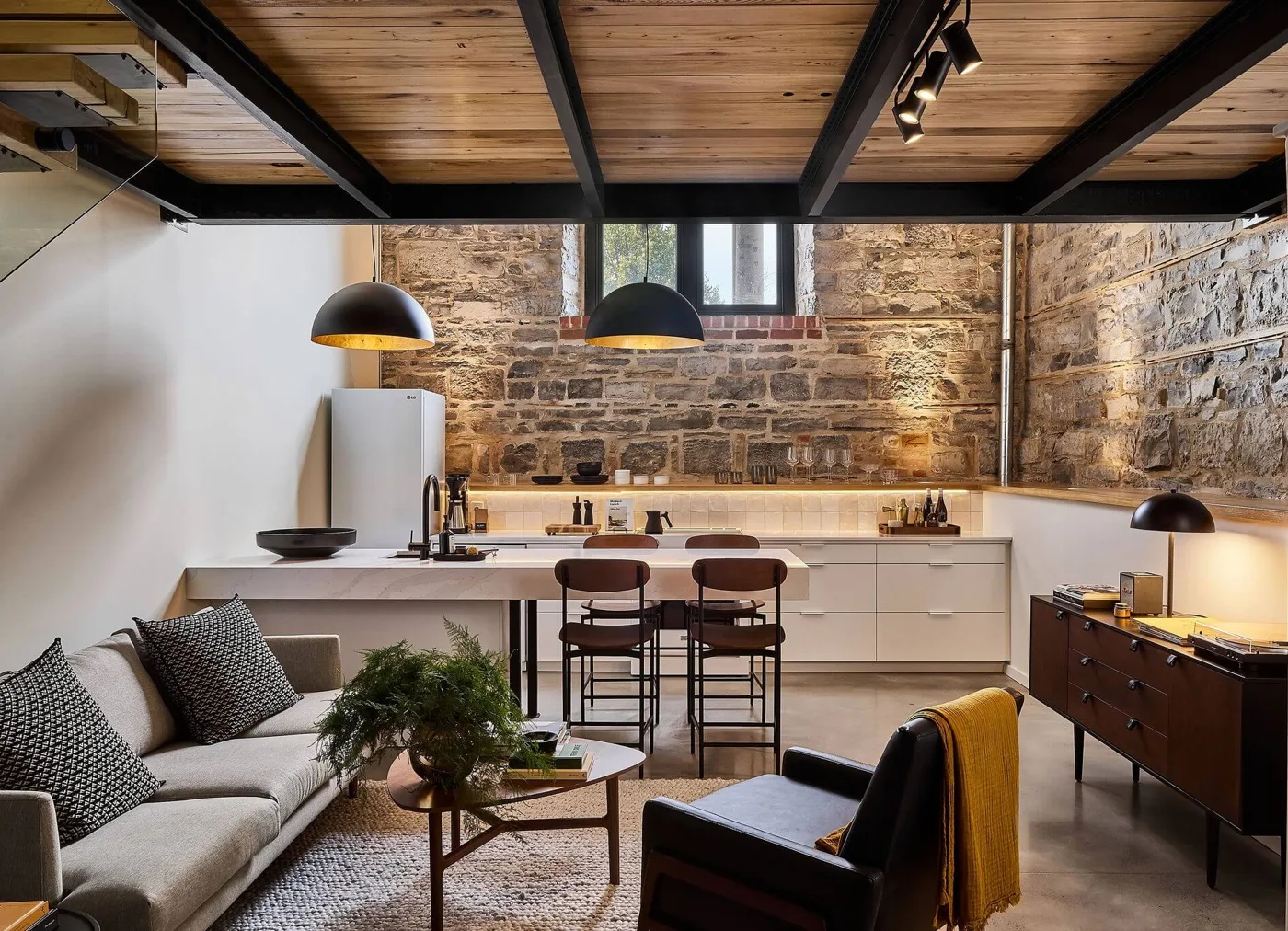 Brick walls, a kitchen and a sitting area in a loft at the Smith Hotel