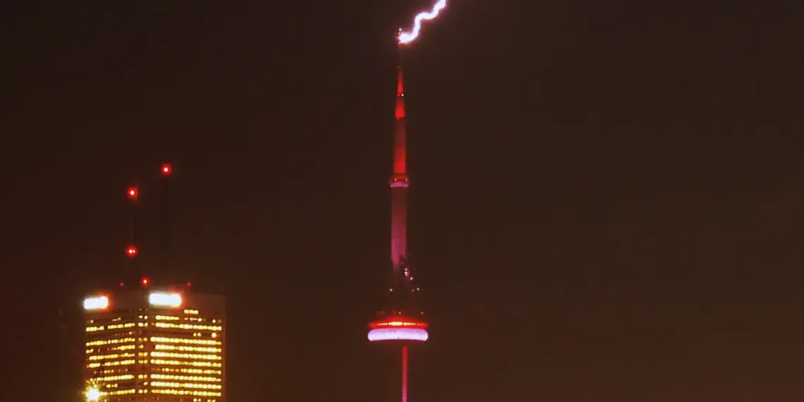 Bright lightning bolt striking the CN Tower during a Toronto storm