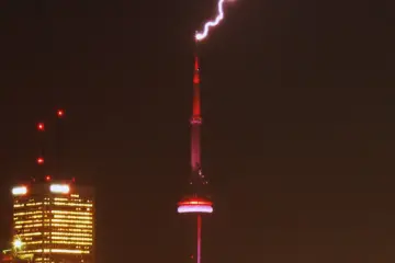 Bright lightning bolt striking the CN Tower during a Toronto storm