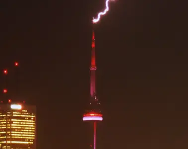 Bright lightning bolt striking the CN Tower during a Toronto storm