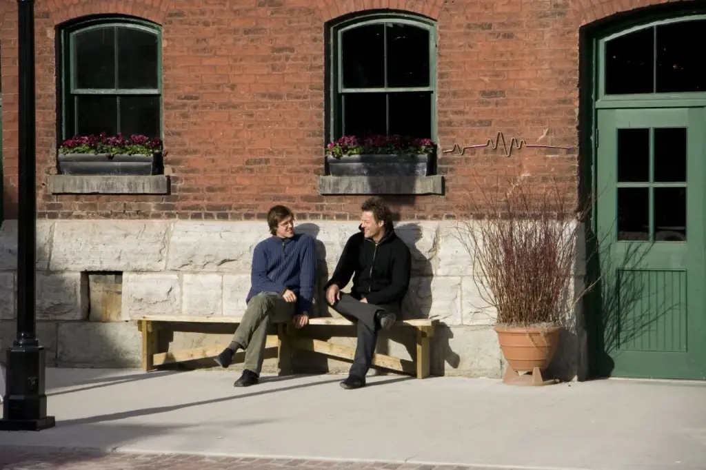 People sitting and walking on a brick pedestrian street in Toronto's Distillery District
