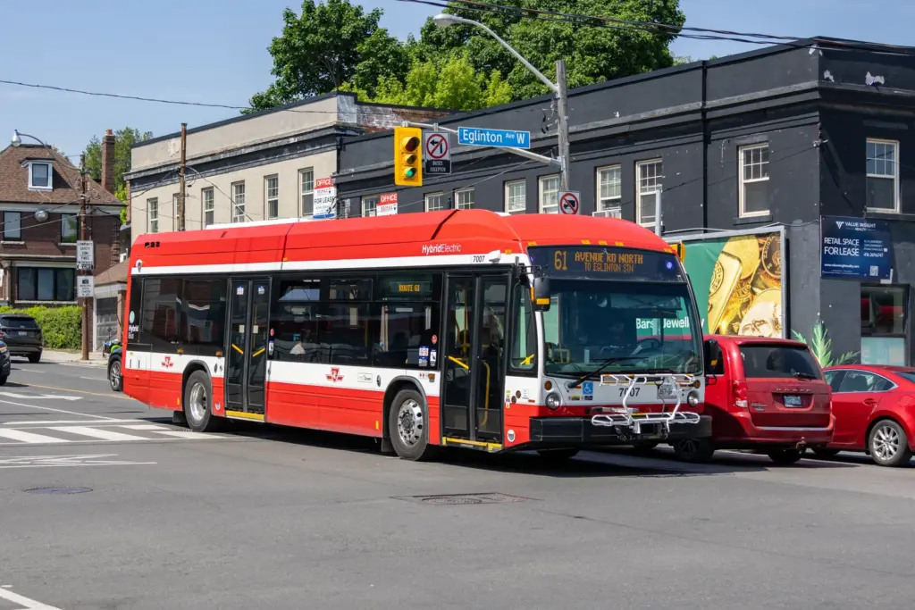Modern TTC bus travelling in mixed traffic on Eglinton Avenue West
