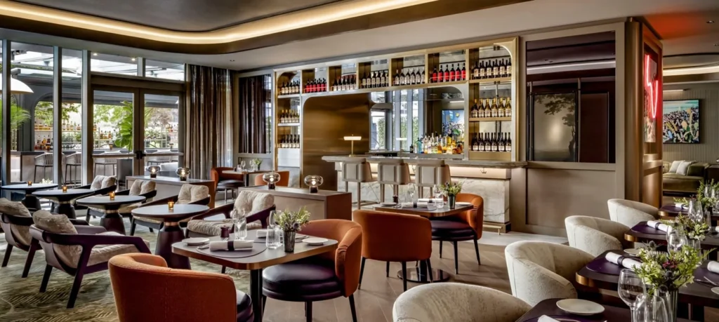 Upholstered chairs, dining tables and the indoor bar at EPOCH Toronto