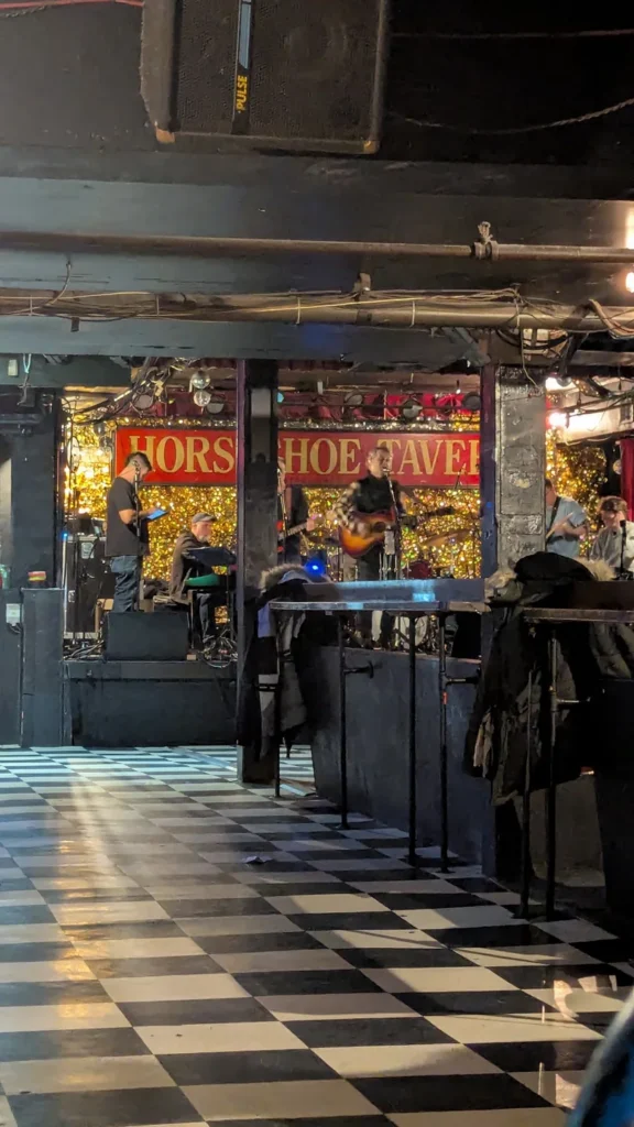 The checkered floor and small stage in the Horseshoe concert room