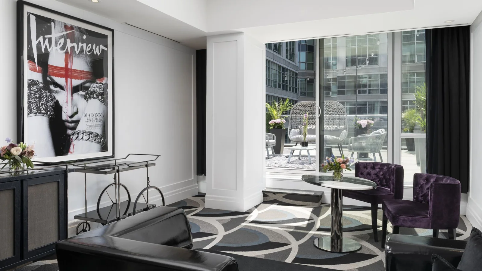 Bisha Marilyn Suite with a sofa and view onto a furnished patio