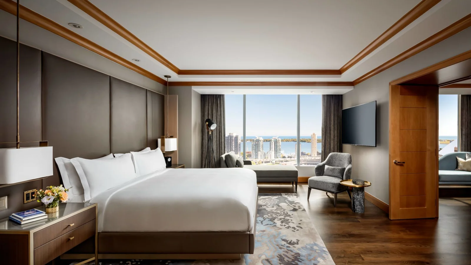 A Ritz-Carlton Toronto bedroom with white bedding and tall windows