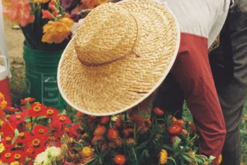 A shopper choosing flowers at Toronto Flower Market