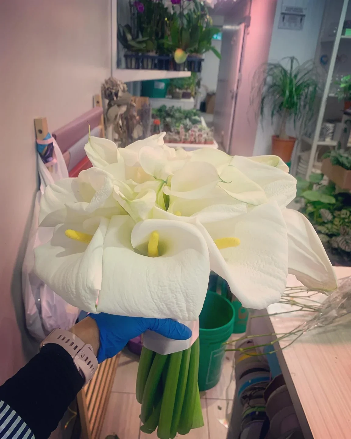 A bunch of white calla lilies held inside Tiny Flower