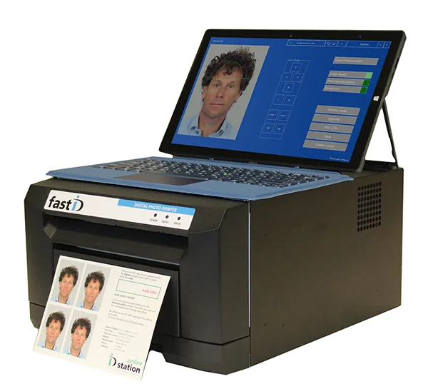 An ID-photo printer and laptop displaying a sample portrait