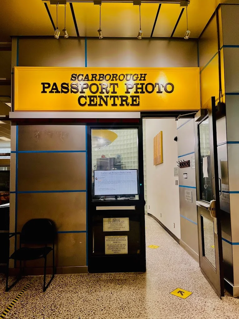 The Scarborough Passport Photo Centre counter beneath a yellow sign