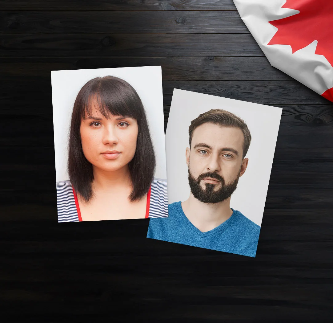 Printed portraits of a woman and a man beside a Canadian flag on a dark table