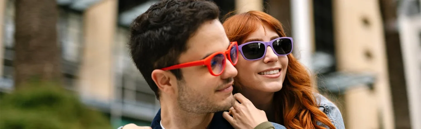 Two people wearing brightly coloured Dresden glasses