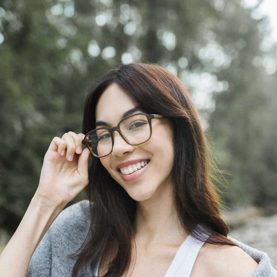 A woman wearing Ollie Quinn glasses outdoors