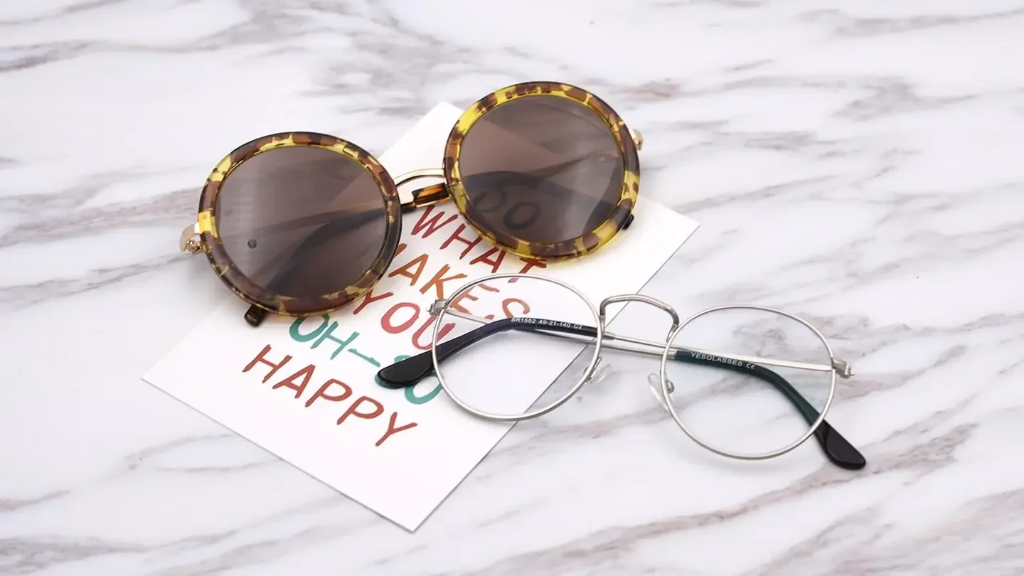 Two pairs of Yesglasses frames on a light surface