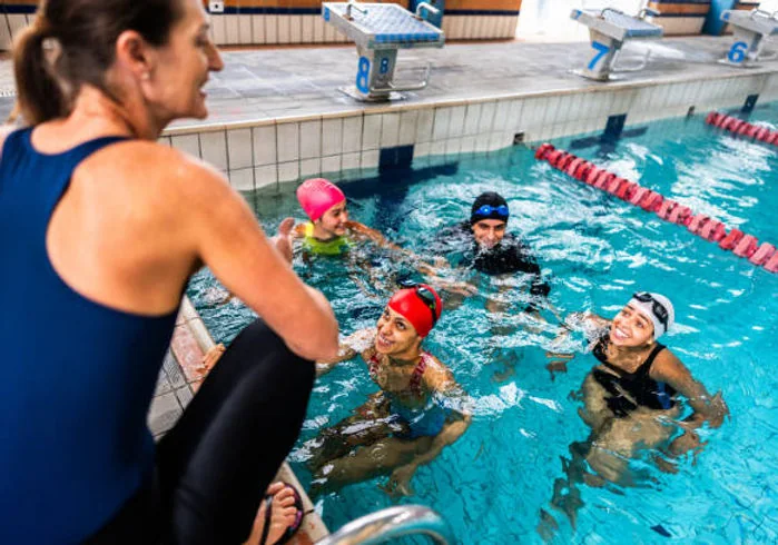 Adult receiving swimming instruction