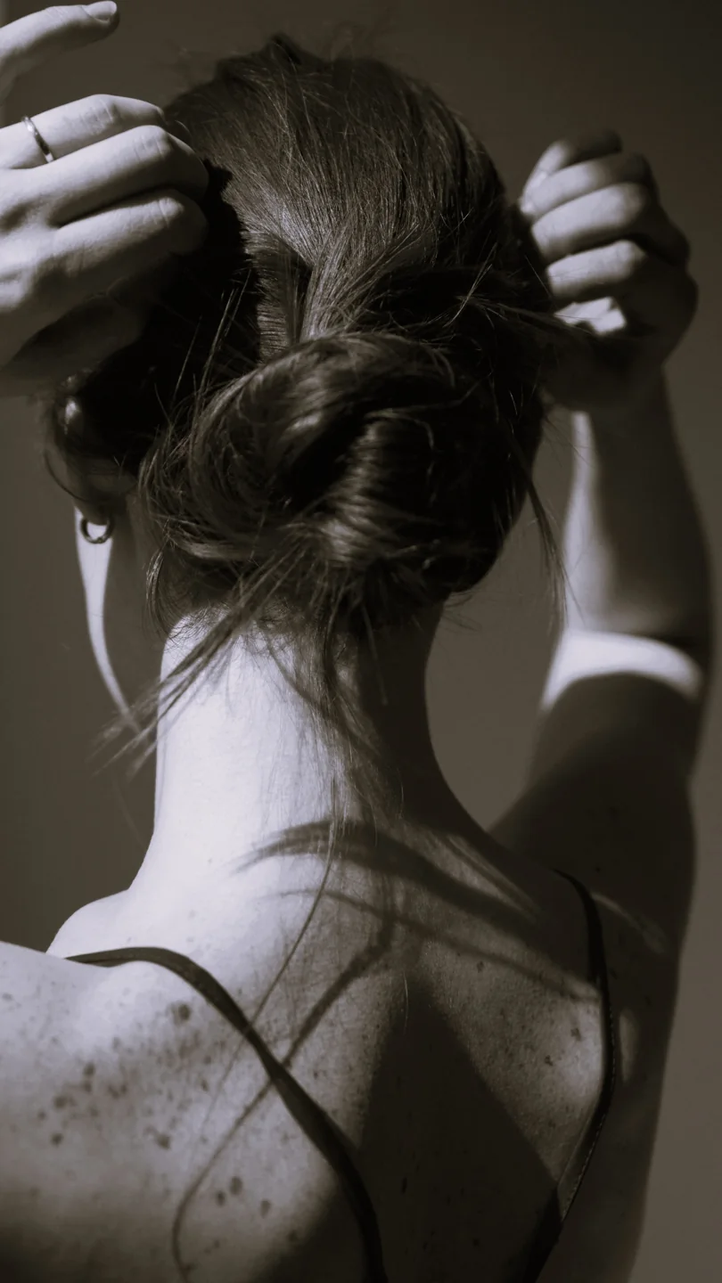 A woman with her hair tied back in a portrait supplied by 03 Hair Salon
