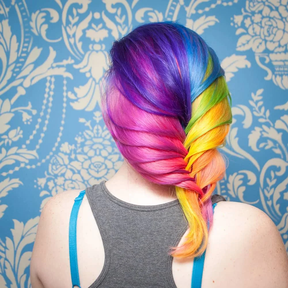 Rainbow-coloured hair arranged in a loose braid, shown by Proudest Pony.