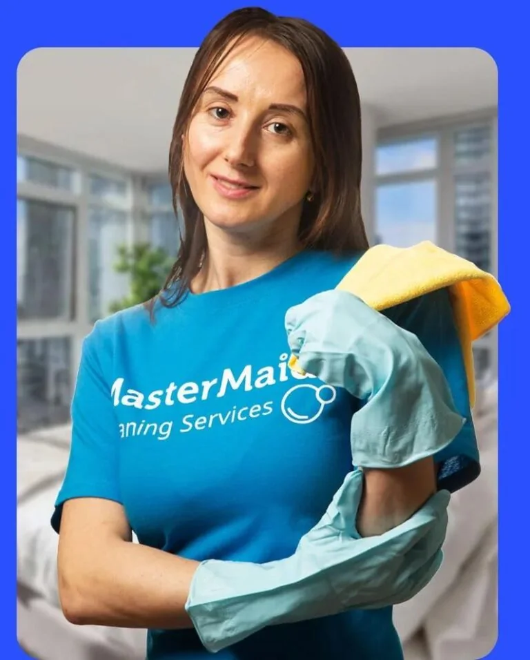 A Master Maid cleaner wearing gloves and holding a cleaning bottle.