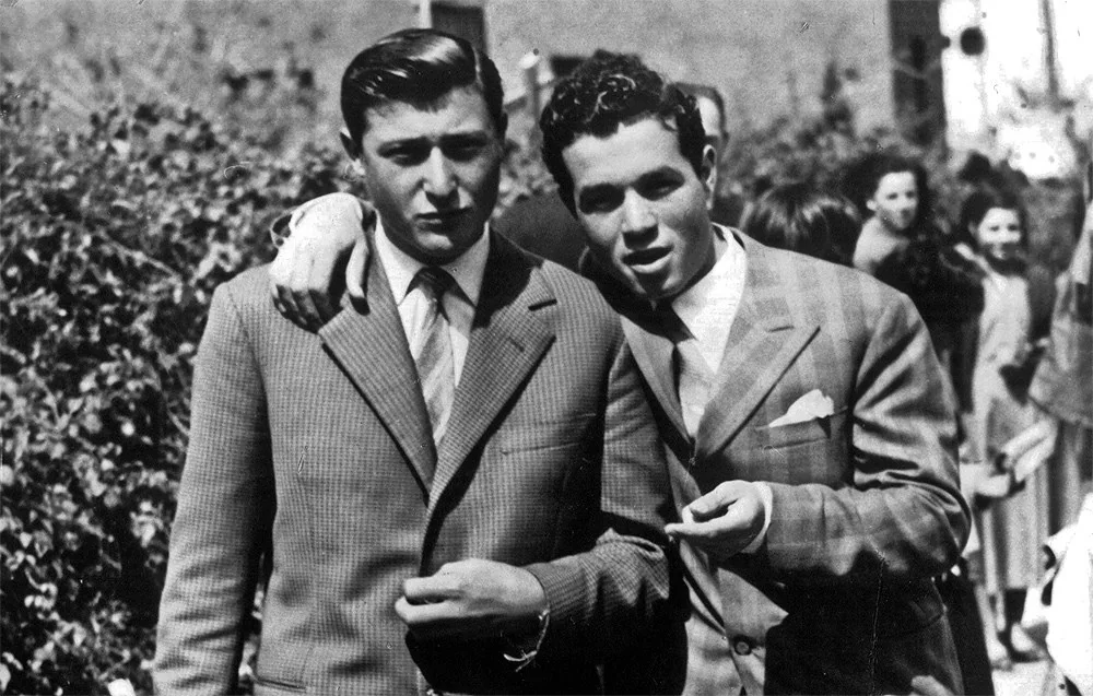 Two men in suits in an archival photograph supplied by Caruso Fine Tailoring