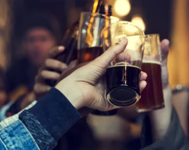 Hands raising beer glasses in a pub photograph supplied by The Rhino