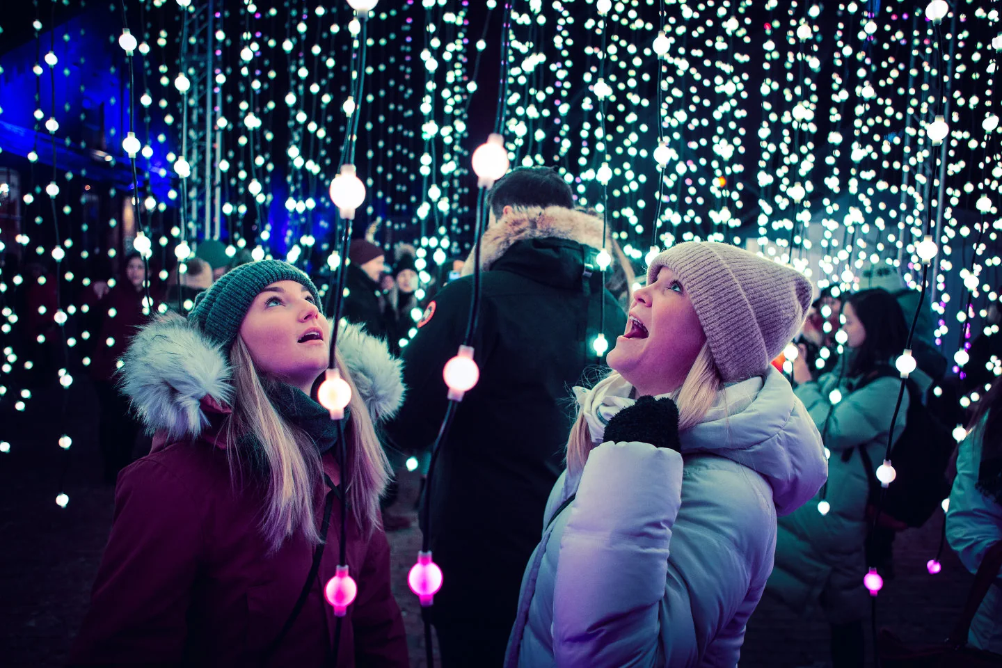 People viewing outdoor light installations in Toronto