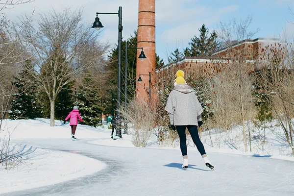 People are skating at the Colonel Samuel Smith outdoor ice rink.