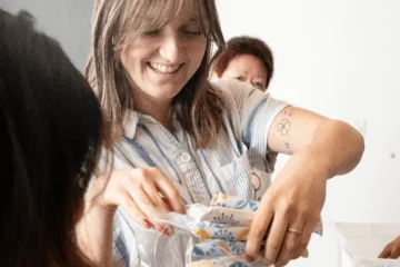 A woman handing out period products
