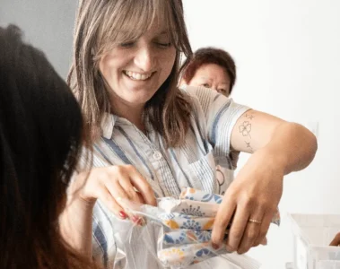 A woman handing out period products