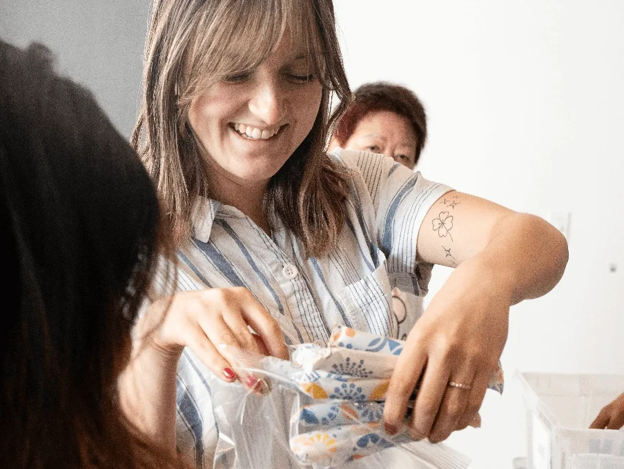 A woman handing out period products