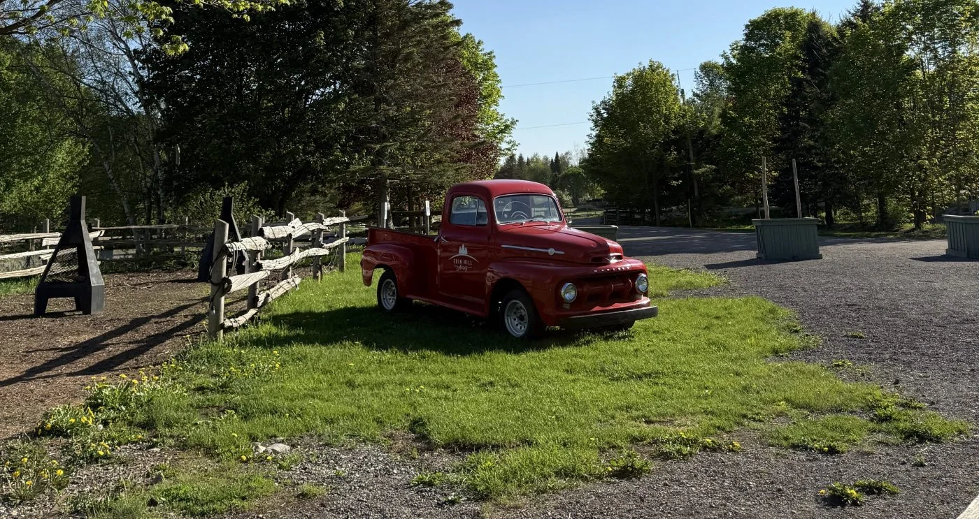 A red farm truck beside a path at Erin Hill Acres