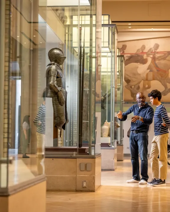 Two visitors looking at a sculpture display at ROM