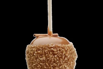 A caramel apple rolled in chopped nuts