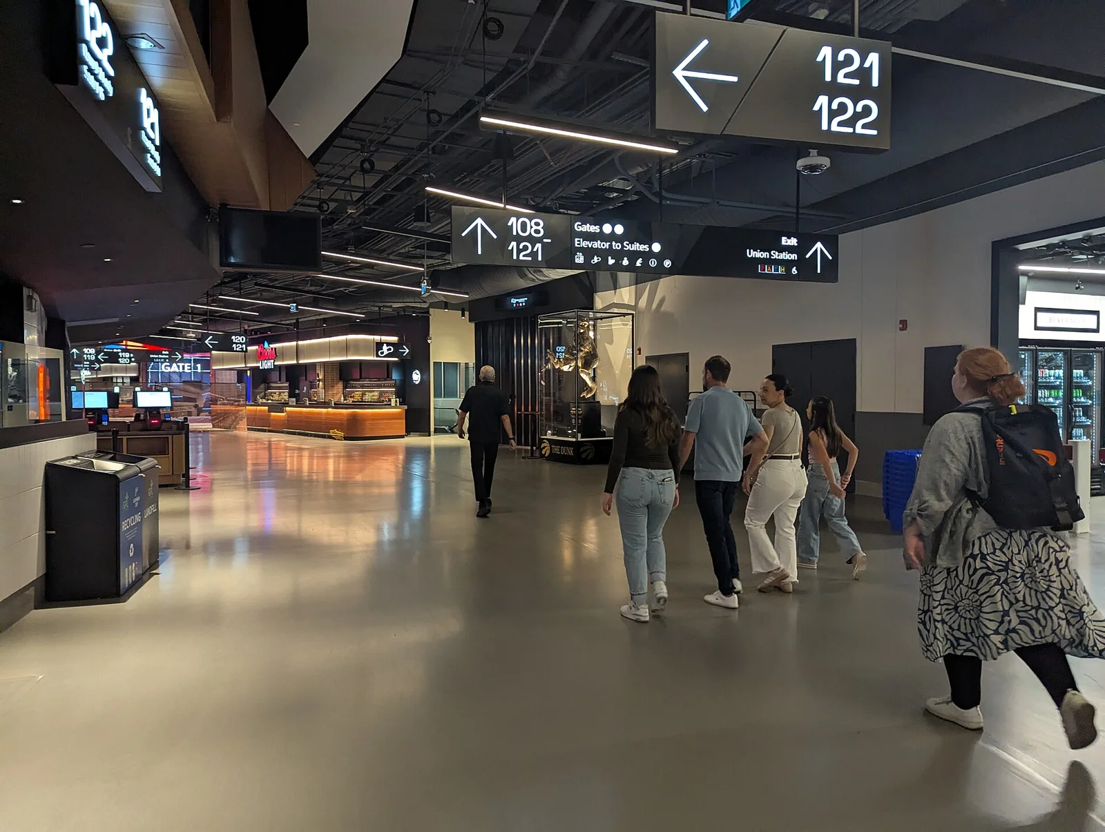 People walking through a Scotiabank Arena concourse