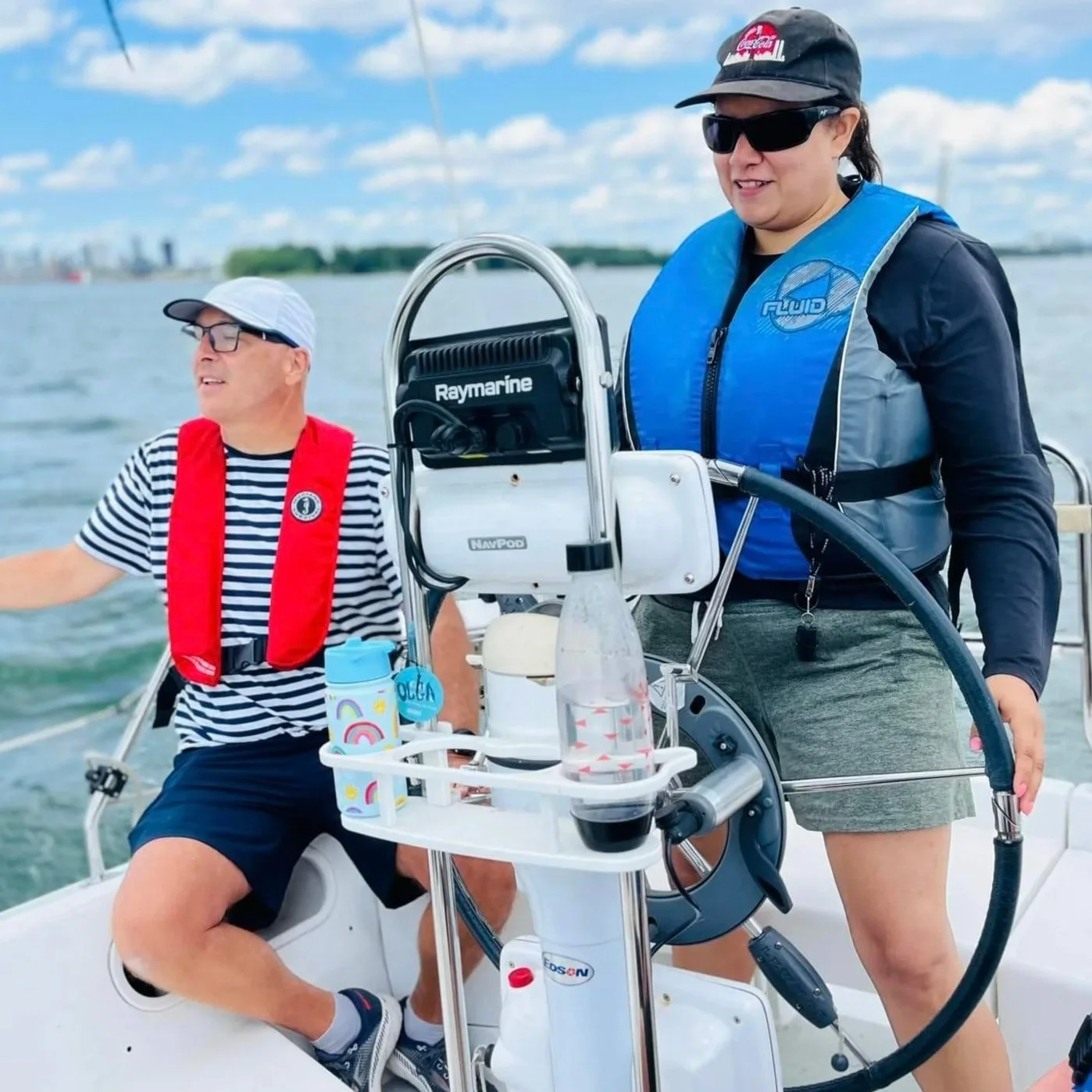 Two participants aboard a sailing boat
