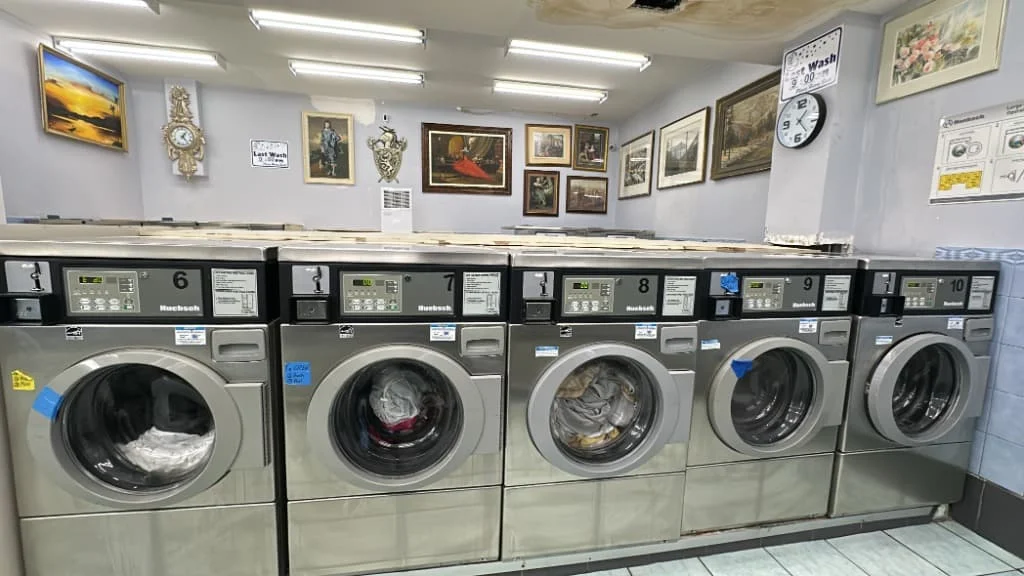 Rows of washers inside Washworld Coin Laundry
