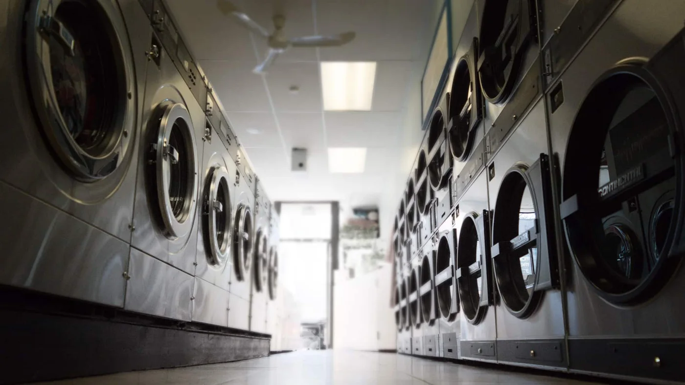 A row of washers and dryers at Quick Clean Laundry