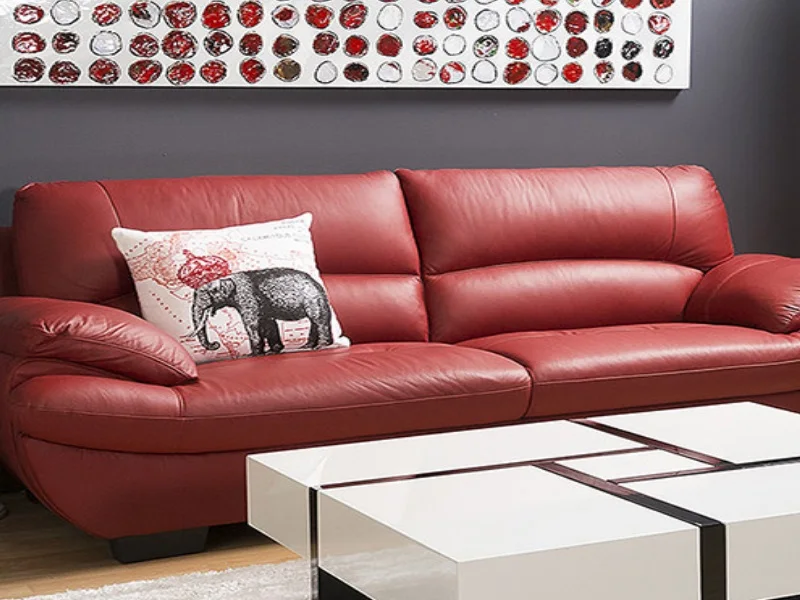 A red leather sofa shown on SteamKleen’s leather-care page
